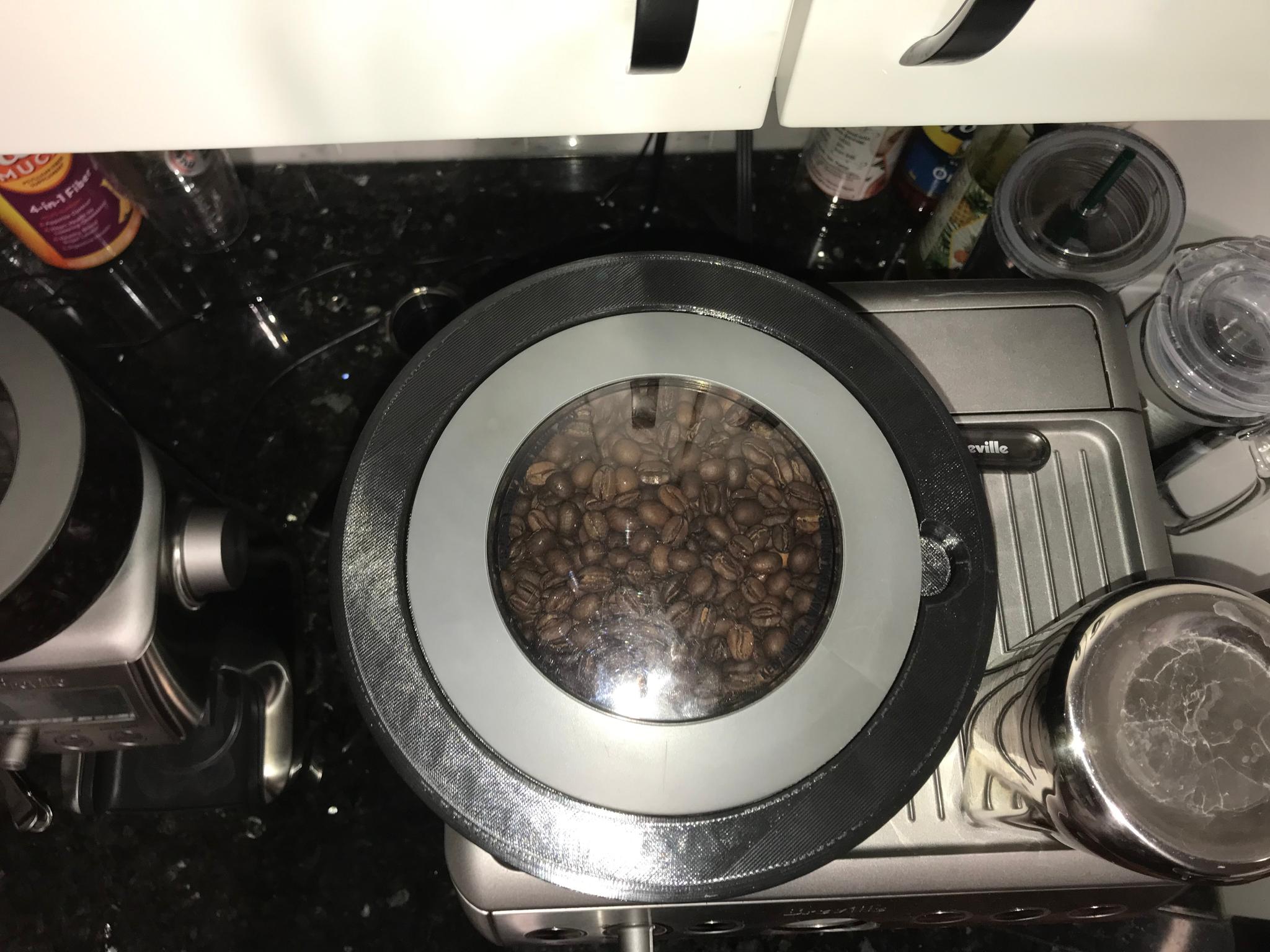 Top view of hopper with lid on Breville machine with coffee beans.