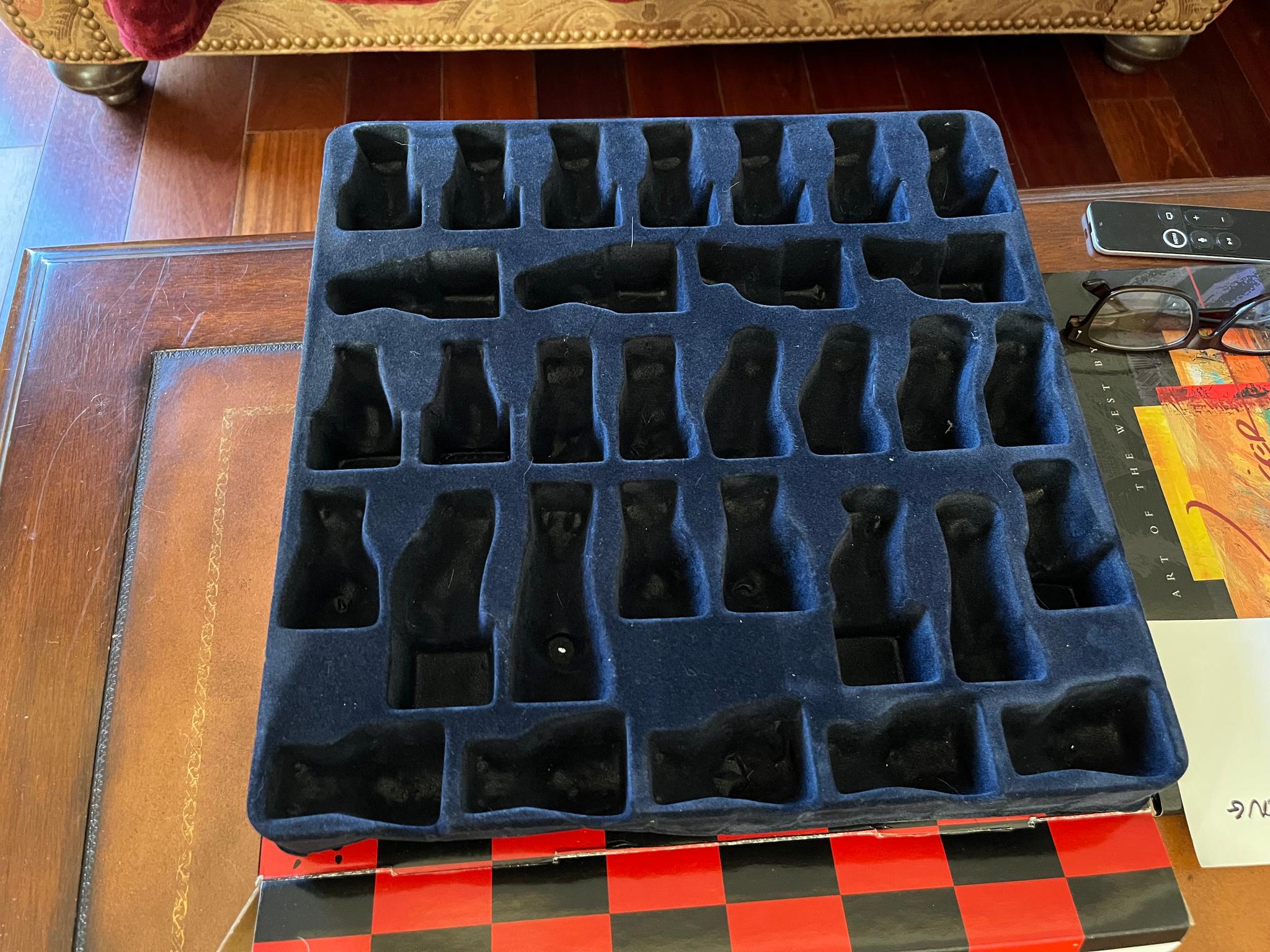 Included container for Cats and Dogs chess pieces.